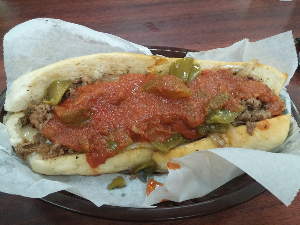 steak hogie with sauce, fried onions, pepper, and provolone