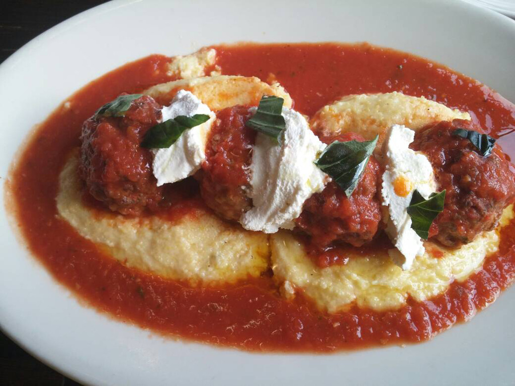 Short rib stuffed balls with creamy polenta, ricotta, and roasted tomato sauce